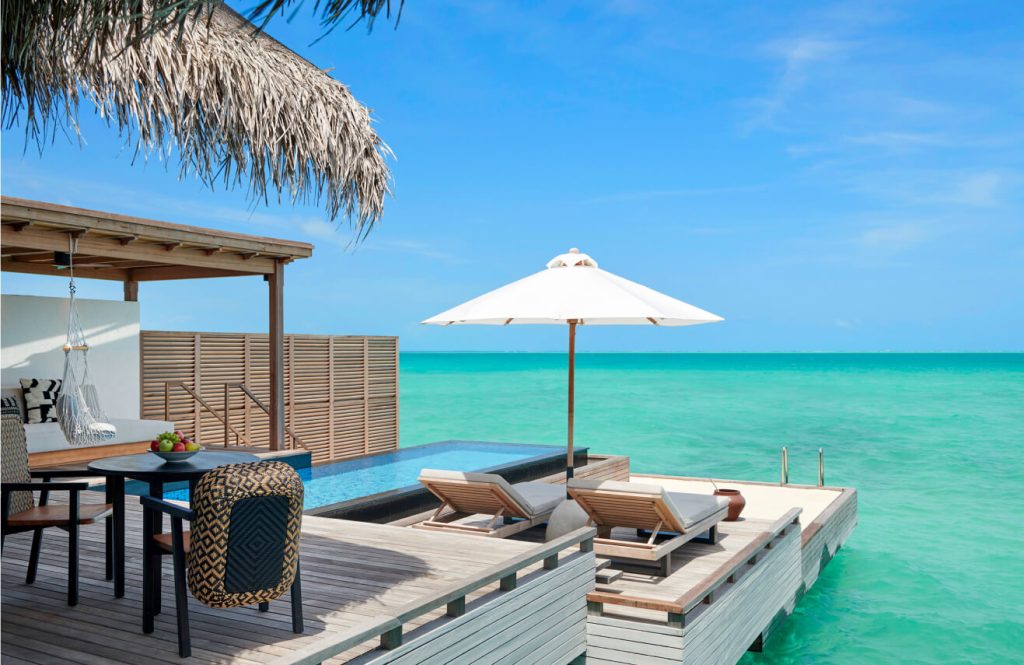 Spacious outdoor deck with private pool at an overwater villa in Sirru Fen Fushi Maldives, offering breathtaking views of the turquoise lagoon and direct access to the ocean