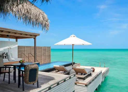 Spacious outdoor deck with private pool at an overwater villa in Sirru Fen Fushi Maldives, offering breathtaking views of the turquoise lagoon and direct access to the ocean