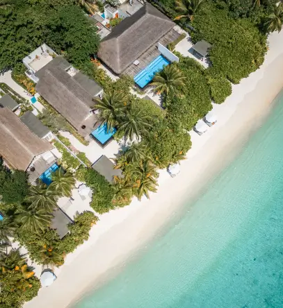 Aerial view of beachfront villas at Sirru Fen Fushi Maldives, each featuring a private pool and direct access to the crystal-clear turquoise lagoon