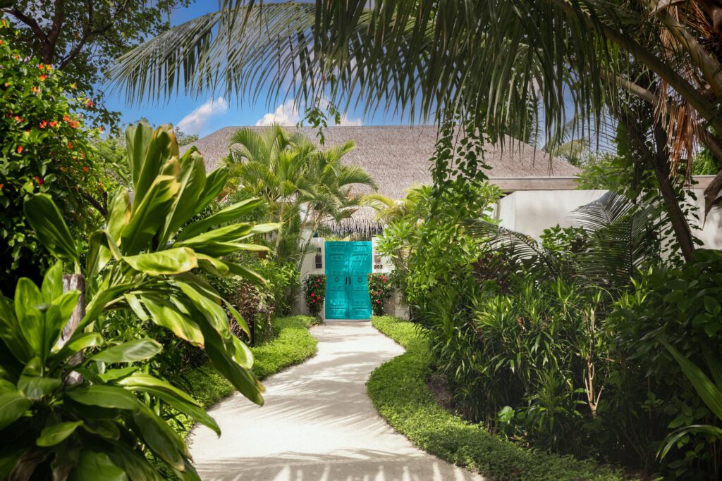 Beach Villa Entrance at Sirru Fen Fushi Resort Maldives with Lush Tropical Foliage and Stunning Ocean Views